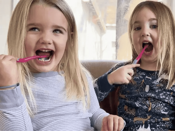 two kids brushing while singing along to the song